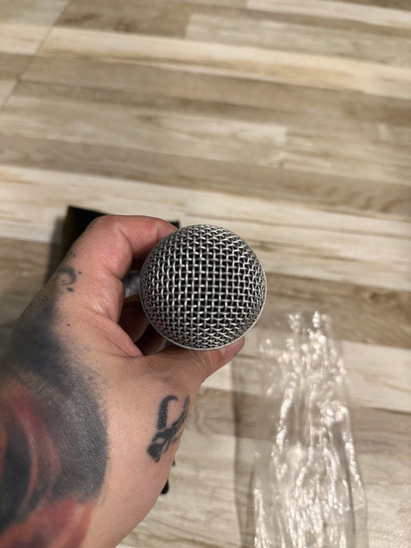 Shure SM58 Dynamic Vocal Microphone with Pouch (Category: Microphones) located in Manila. Submitted by safeowl.b6dbb0 (Listing ID 1467163975, Image 3). Description: Shure SM58 dynamic microphone, legendary for live vocals and studio sessions. Robust metal construction with steel mesh grille. Includes original Shure branded black zipper pouch. Standard XLR connection at the base. Clean body finish, no major dents or scratches visible on the grille