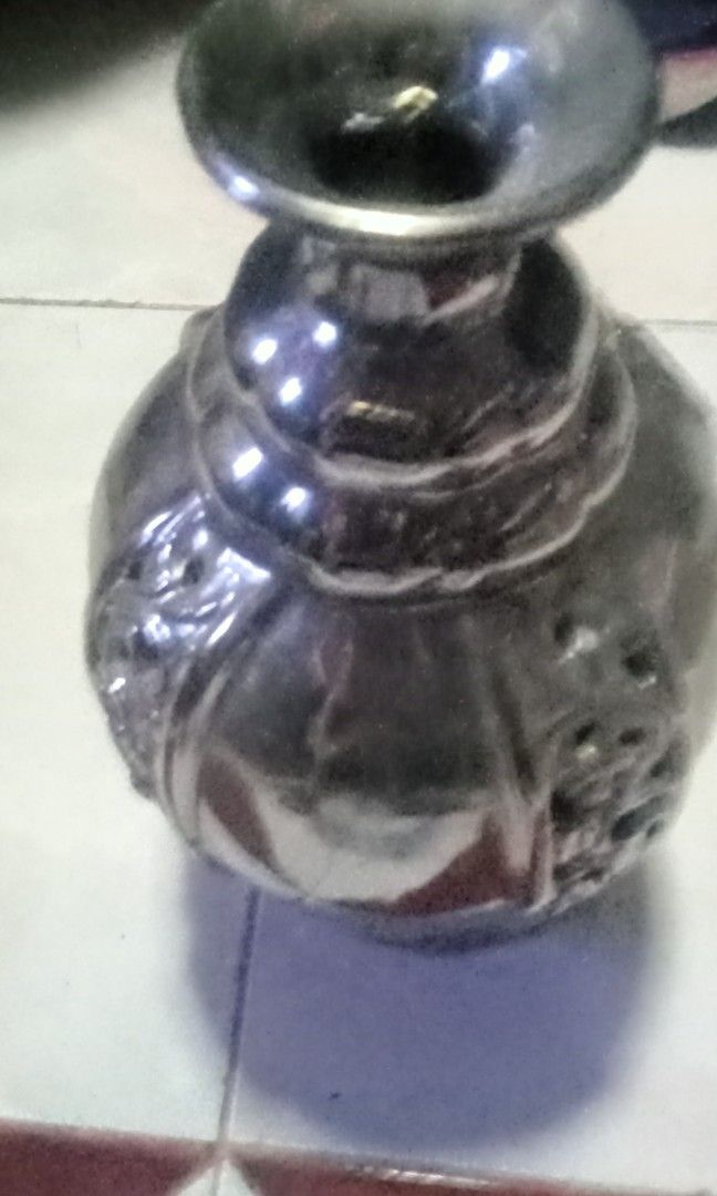 Silver Decorative Vase with Ornate Cutout Design (Category: Vases & Decorative Bowls) located in Paranaque City. Submitted by dimaguilaa94969 (Listing ID 1460054204, Image 2). Description: - Beautiful silver vase - Features an intricate cutout pattern around the middle - Ribbed detail on the neck - Classic urn shape with a flared opening - Ideal for displaying flowers or as a standalone decorative piece - Adds a touch of elegance to any room.