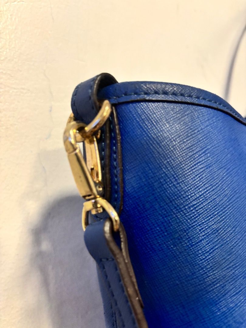 Sisley Blue Tote Bag (Category: Tote Bags) located in Pasay City. Submitted by kgemsluxuryboutique (Listing ID 1467104581, Image 3). Description: - Brand: Sisley (Made in Italy) - Material: Textured saffiano leather in a vibrant bright blue - Hardware: Elegant gold-tone accents, including front brand plaque and strap buckles - Versatility: Dual top handles plus a detachable long strap for shoulder or crossbody wear - Design: Structured, spacious 
