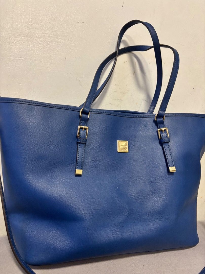 Sisley Blue Tote Bag (Category: Tote Bags) located in Pasay City. Submitted by kgemsluxuryboutique (Listing ID 1467104581, Image 1). Description: - Brand: Sisley (Made in Italy) - Material: Textured saffiano leather in a vibrant bright blue - Hardware: Elegant gold-tone accents, including front brand plaque and strap buckles - Versatility: Dual top handles plus a detachable long strap for shoulder or crossbody wear - Design: Structured, spacious 