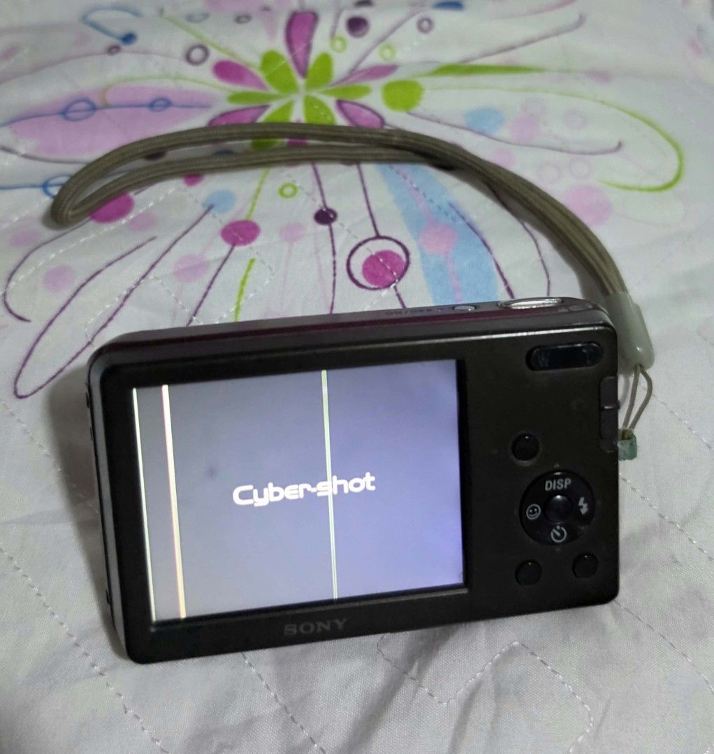 Sony Cyber-shot Pink Digicam (Category: Other Gadgets) located in Manila. Submitted by nikicam (Listing ID 1466973214, Image 3). Description: Camera Details: Brand: Sony Cyber-shot Resolution: 12.1 Megapixels 4x Optical Zoom Color: Pink Condition: *Pre-loved with visible scratches and signs of use. *The LCD screen has double vertical lines. *No sample photos or output available because no memory card is included. *Camera functionality is not full