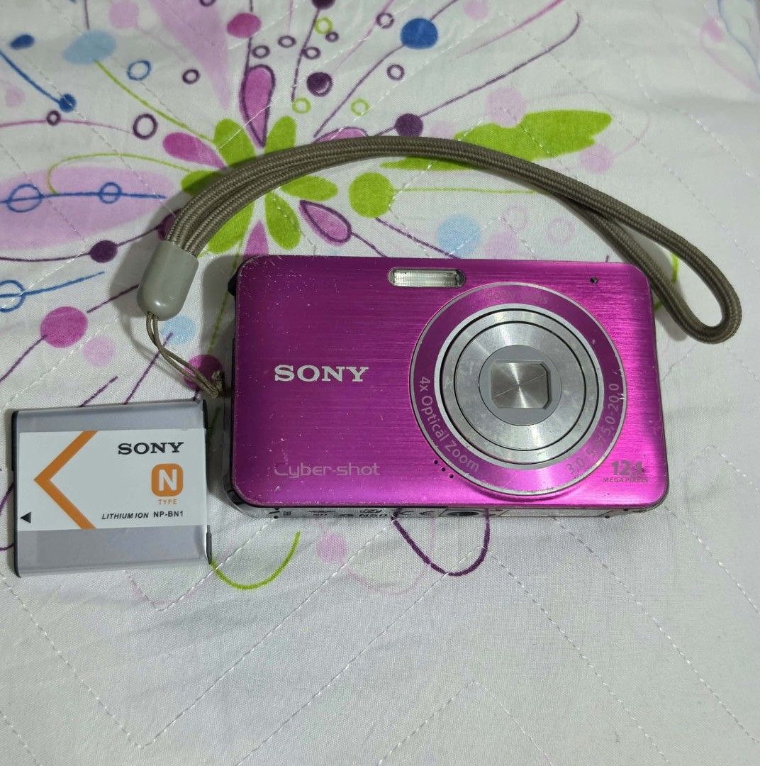 Sony Cyber-shot Pink Digicam (Category: Other Gadgets) located in Manila. Submitted by nikicam (Listing ID 1466973214, Image 1). Description: Camera Details: Brand: Sony Cyber-shot Resolution: 12.1 Megapixels 4x Optical Zoom Color: Pink Condition: *Pre-loved with visible scratches and signs of use. *The LCD screen has double vertical lines. *No sample photos or output available because no memory card is included. *Camera functionality is not full