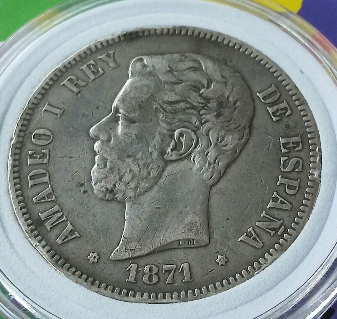 Spain 5 Pesetas 1871 Silver Coin (Category: Currency) located in Quezon City. Submitted by allaboutcollectibles (Listing ID 1467010404, Image 3). Description: What you see is what you get. Issuer: Spain Year: 1871 Value: 5 Pesetas Composition: Silver (.900) Weight: 25 g Diameter: 37 mm Thickness: 2 mm This coin is guaranted genuine, thank you for visiting my store..
