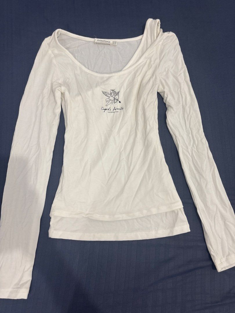 Stradivarius White Cupid Graphic Long Sleeve Top (Category: Longsleeves) located in Makati City. Submitted by blueberrylime (Listing ID 1466975492, Image 1). Description: - Brand: Stradivarius - Size: XS - Color: White - Design: Scoop neckline with asymmetric strap detail, front cupid graphic - Material: Soft, lightweight fabric - Origin: Made in Turkey - Condition: Brand new / Excellent.