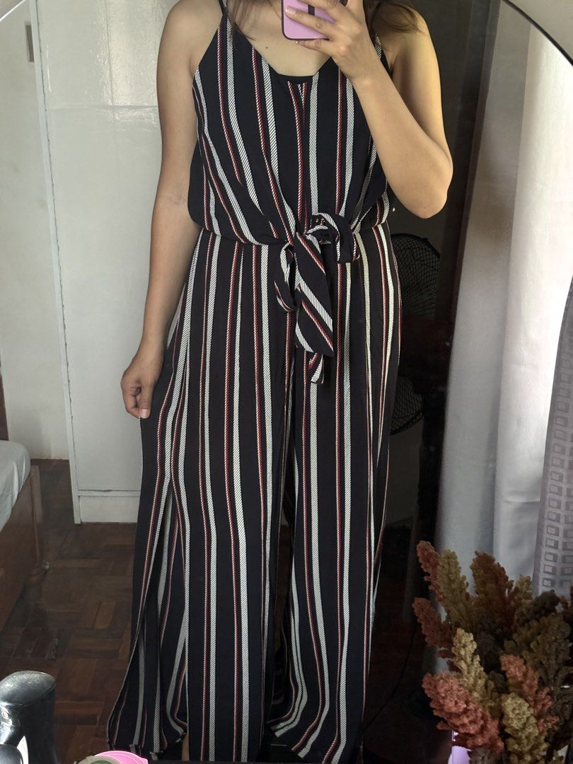 Striped Spaghetti Strap Jumpsuit with Front Tie (Category: Jumpsuits) located in Santo Niño. Submitted by ysayaye (Listing ID 1467030600, Image 1). Description: - Color/Pattern: Navy blue with stylish white and red vertical stripes - Design: Spaghetti straps, V-neckline, and an adjustable front tie at the waist - Style: Trendy wide-leg pants with a chic high side slit on one leg - Material: Lightweight, breathable fabric for ultimate comfort - Be