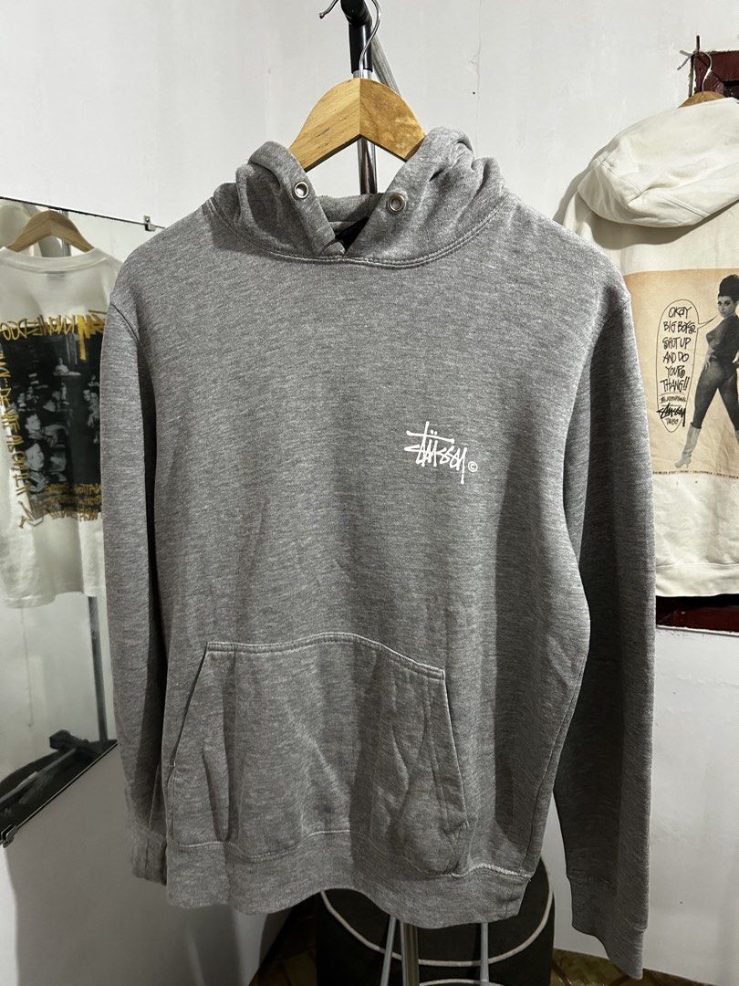 Stussy Grey Hoodie Small (Category: Hoodies) located in Manila. Submitted by livedog-d301 (Listing ID 1467132313, Image 2). Description: - Brand: Stussy - Size: Small - Color: Grey - Material: 80% cotton, 20% polyester blend (soft and comfortable) - Design: Classic logo on chest and large logo print on the back - Features: Front kangaroo pocket, metal eyelets on the hood - Condition: Clean tags intact at neckline and inside.