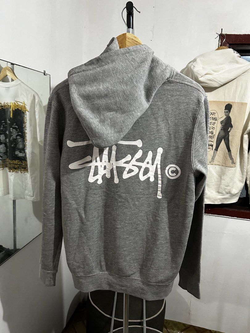 Stussy Grey Hoodie Small (Category: Hoodies) located in Manila. Submitted by livedog-d301 (Listing ID 1467132313, Image 1). Description: - Brand: Stussy - Size: Small - Color: Grey - Material: 80% cotton, 20% polyester blend (soft and comfortable) - Design: Classic logo on chest and large logo print on the back - Features: Front kangaroo pocket, metal eyelets on the hood - Condition: Clean tags intact at neckline and inside.