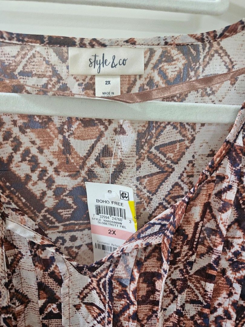 Style & Co Boho Free Geometric Print Blouse (Category: Blouses) located in Santo Tomas. Submitted by buybugs (Listing ID 1467131708, Image 3). Description: - Brand: Style & Co - Size: 2X (Brand new with original store tags) - Pattern: Brown, cream, and navy geometric tribal print - Features: V-neckline with tassel tie strings, long flared sleeves with tiered ruffles - Fabric: Lightweight and sheer - Buyer will cover the shipping fee: Flash| J&T |
