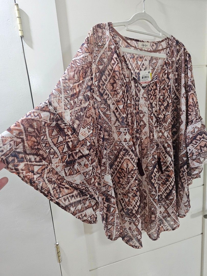 Style & Co Boho Free Geometric Print Blouse (Category: Blouses) located in Santo Tomas. Submitted by buybugs (Listing ID 1467131708, Image 2). Description: - Brand: Style & Co - Size: 2X (Brand new with original store tags) - Pattern: Brown, cream, and navy geometric tribal print - Features: V-neckline with tassel tie strings, long flared sleeves with tiered ruffles - Fabric: Lightweight and sheer - Buyer will cover the shipping fee: Flash| J&T |