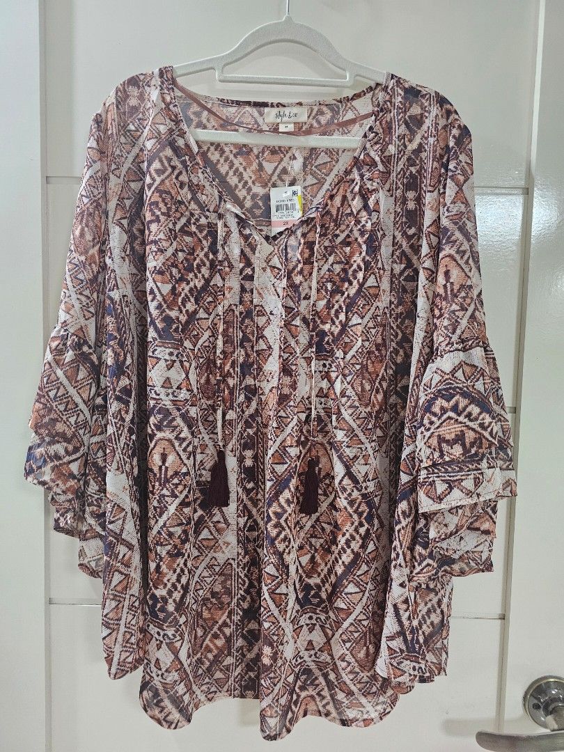 Style & Co Boho Free Geometric Print Blouse (Category: Blouses) located in Santo Tomas. Submitted by buybugs (Listing ID 1467131708, Image 1). Description: - Brand: Style & Co - Size: 2X (Brand new with original store tags) - Pattern: Brown, cream, and navy geometric tribal print - Features: V-neckline with tassel tie strings, long flared sleeves with tiered ruffles - Fabric: Lightweight and sheer - Buyer will cover the shipping fee: Flash| J&T |