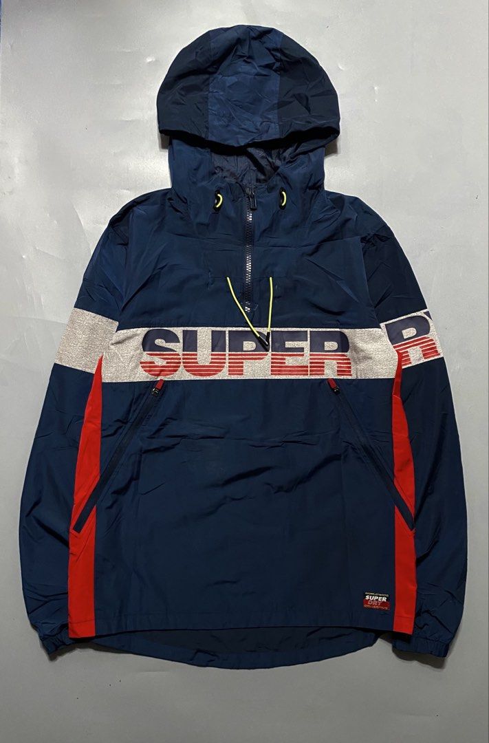 Superdry Hooded Windbreaker Jacket Navy Blue (Category: Coats, Jackets and Outerwear) located in Manila. Submitted by delunakenn94368 (Listing ID 1467141643, Image 1). Description: - Brand: Superdry waterproof - Type: Men's Sport Hooded Jacket / Windbreaker - Color: Navy blue with grey chest panel, red side panels, and bold branding - Features: Neon yellow drawstrings, matching sleeve details, and front zip pockets - Fit: Regular fit - Condition: