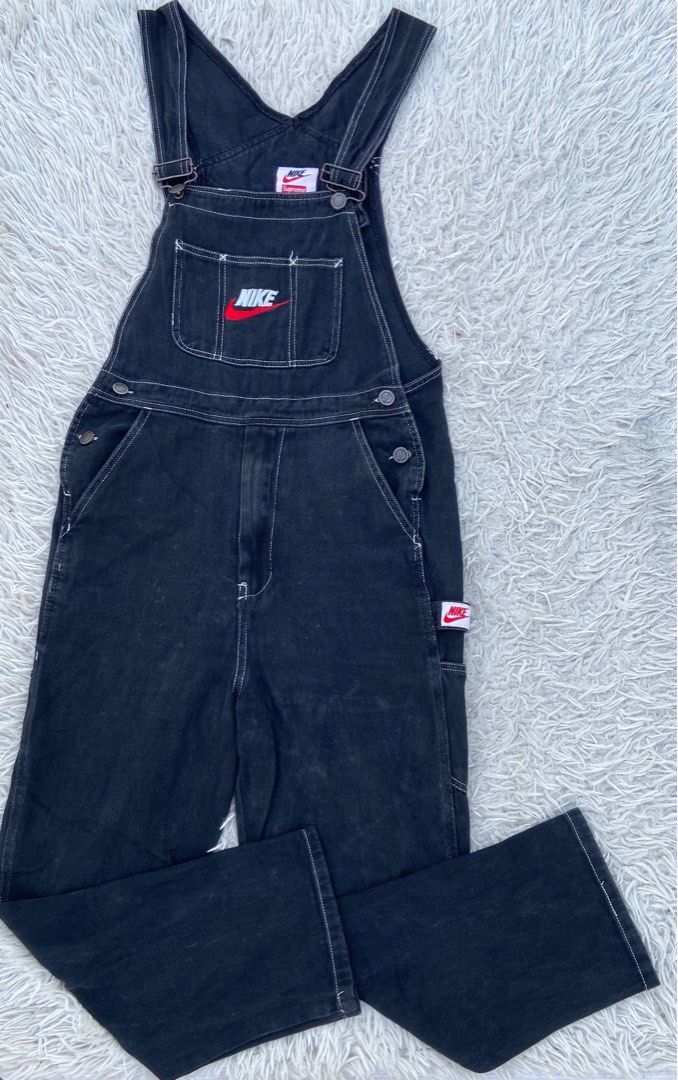 Supreme x Nike Black Denim Overalls (Category: Jumpsuits) located in Manila. Submitted by arar_ramos (Listing ID 1467062424, Image 1). Description: - Brand: Supreme x Nike - Item: Black Denim Overalls - Details: Heavyweight denim with contrasting white stitching - Branding: Embroidered Nike Swoosh on chest pocket, red Nike logo tag on utility side pocket - Hardware: Adjustable shoulder straps with metal hardware and multiple side button closures 