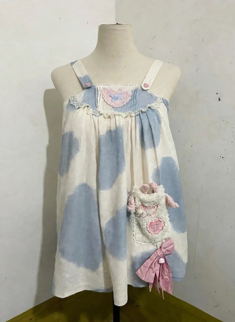 Sweet Lolita Jumper (Category: Others Tops) located in Cavite. Submitted by angelic.clot (Listing ID 1467022597, Image 1). Description: - Brand: TaTaTa Lolita (Legit Taobao Lolita brand) - Color: Off-white / Baby Blue cow print + Baby pink accents - Style: Babydoll / JSK, sleeveless with adjustable heart button straps - Features: - Embroidered pink heart with blue bow sa chest - White lace frill + star bows - Detachable fluffy bunny pocket with e