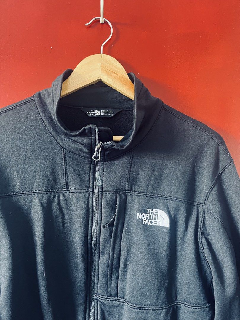 The North Face Men's Apex Bionic Softshell Jacket in black. (Category: Activewear) located in Quezon City. Submitted by wacpon_061972 (Listing ID 1446062143, Image 2). Description: This black The North Face softshell jacket features a zippered chest pocket and embroidered branding. (W-23/L-28).