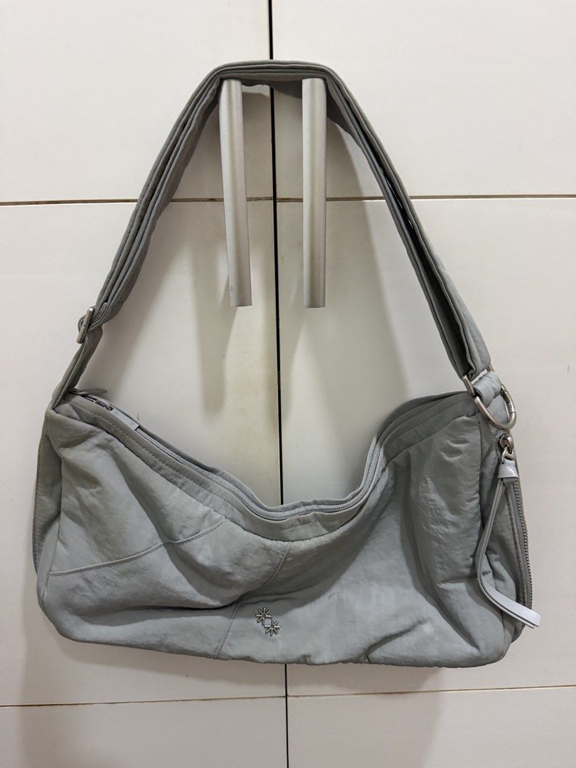 The Paper Bunny Vessel Bag (Category: Shoulder Bags) located in Davao. Submitted by pamdyclutters (Listing ID 1467138784, Image 1). Description: - Brand: The Paper Bunny - Color & Material: Grey crinkled nylon - Style: Slouchy hobo everyday carryall - Hardware: Adjustable strap with silver metal and engraved branding, plus twin flower-shaped metal studs near the base - Storage: Top zip closure and convenient side zip pocket - Condition: Clean ext