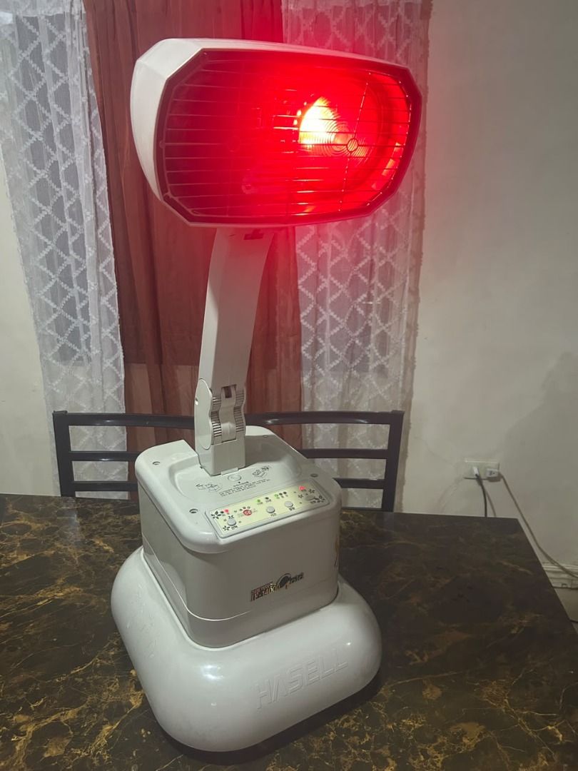 Therapy heating light (Category: Air Conditioning and Heating) located in Taguig. Submitted by lhadychinitah (Listing ID 1467144048, Image 2). Description: This is a Hasell IF-14000 Gold infrared therapeutic device used for heat therapy and sitz baths. Model: Hasell IF-14000 Gold. Function: Infrared medical device designed for household use. Versatility: Primarily used for heat treatment and can be utilized for sitz baths..