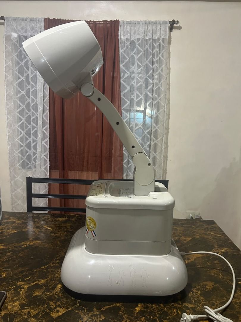 Therapy heating light (Category: Air Conditioning and Heating) located in Taguig. Submitted by lhadychinitah (Listing ID 1467144048, Image 3). Description: This is a Hasell IF-14000 Gold infrared therapeutic device used for heat therapy and sitz baths. Model: Hasell IF-14000 Gold. Function: Infrared medical device designed for household use. Versatility: Primarily used for heat treatment and can be utilized for sitz baths..