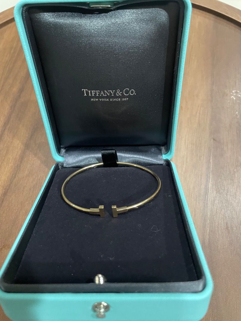 Authentic Tiffany & Co. T Wire Bracelet Gold (Category: Bracelets) located in Quezon City. Submitted by yenggaytot76 (Listing ID 1467099857, Image 2). Description: - Authentic Gold Tiffany & Co. wire bracelet - Iconic T-end design with minimalist open-cuff style - Easy to slip on and off the wrist - Includes original Tiffany turquoise presentation box with black interior lining - Classic and timeless piece perfect for daily wear or gifting.