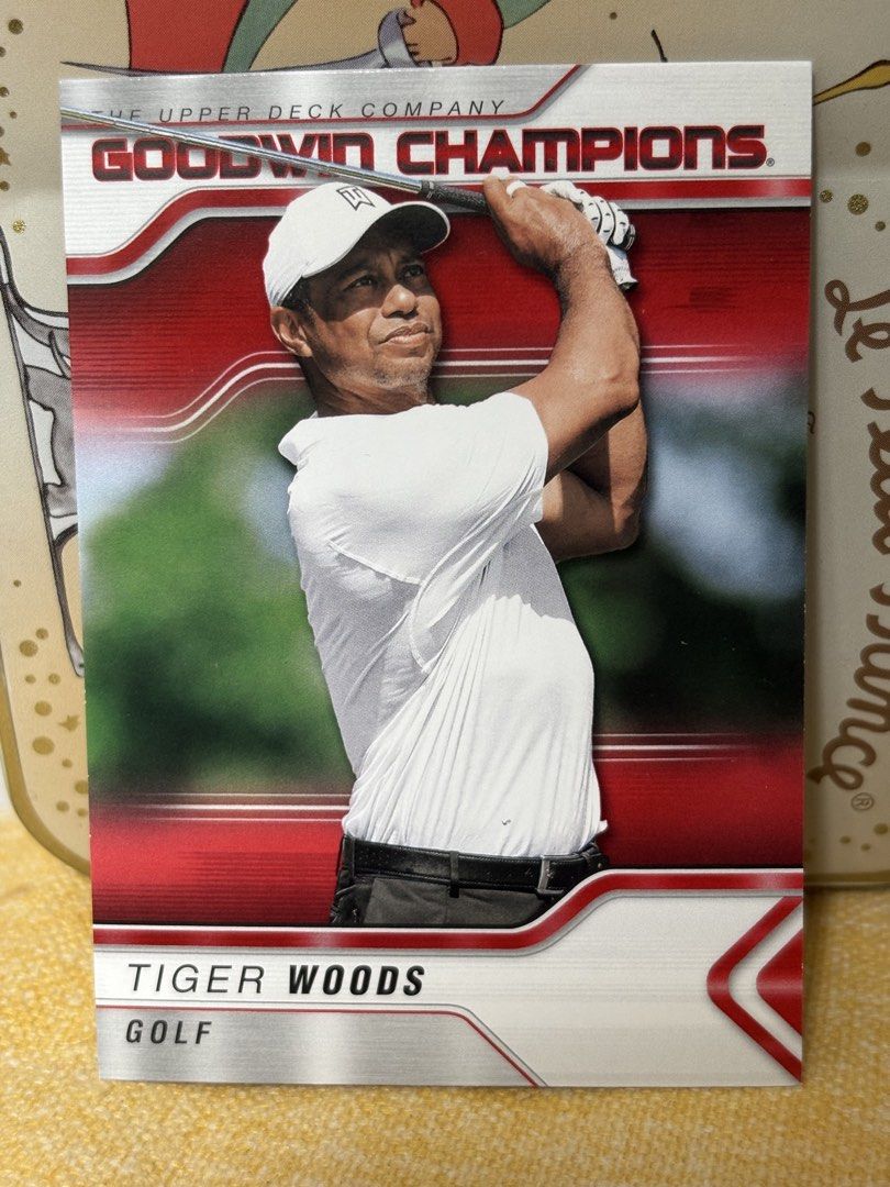 Tiger Woods (Category: Raw Singles) located in Las Pinas. Submitted by kapkards (Listing ID 1467000068, Image 1). Description: - Player: Tiger Woods - Set: Upper Deck Goodwin Champions - Design: Metallic silver borders with red background accents, featuring Tiger mid-swing - Condition: Clean edges and corners - Size: Standard trading card - Ideal for: Sports card collectors and golf enthusiasts - Shipping: Packed securely with top loader and slee
