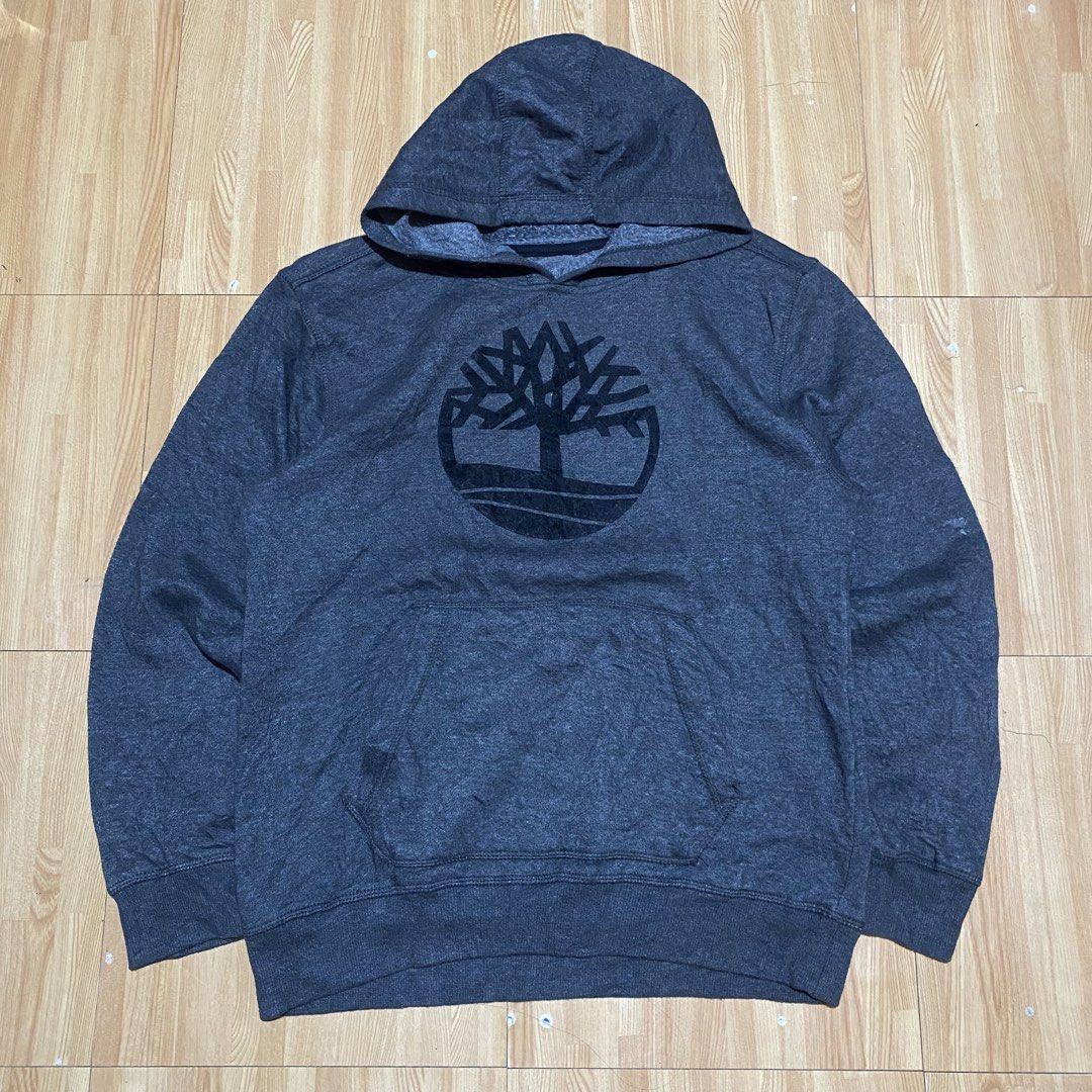 Timberland Hood (Category: Coats, Jackets and Outerwear) located in Manila. Submitted by killthismane (Listing ID 1467098021, Image 1). Description: Timberland Tree Logo Fleece Pullover Hoodie dark grey/heather charcoal featuring a large circular Timberland tree graphic on the chest and a front kangaroo pocket. Size S (19/24).