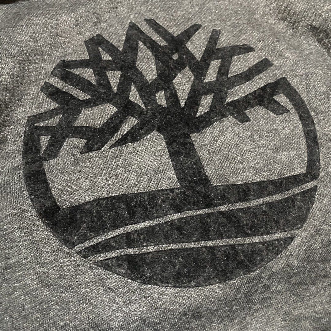 Timberland Hood (Category: Coats, Jackets and Outerwear) located in Manila. Submitted by killthismane (Listing ID 1467098021, Image 3). Description: Timberland Tree Logo Fleece Pullover Hoodie dark grey/heather charcoal featuring a large circular Timberland tree graphic on the chest and a front kangaroo pocket. Size S (19/24).