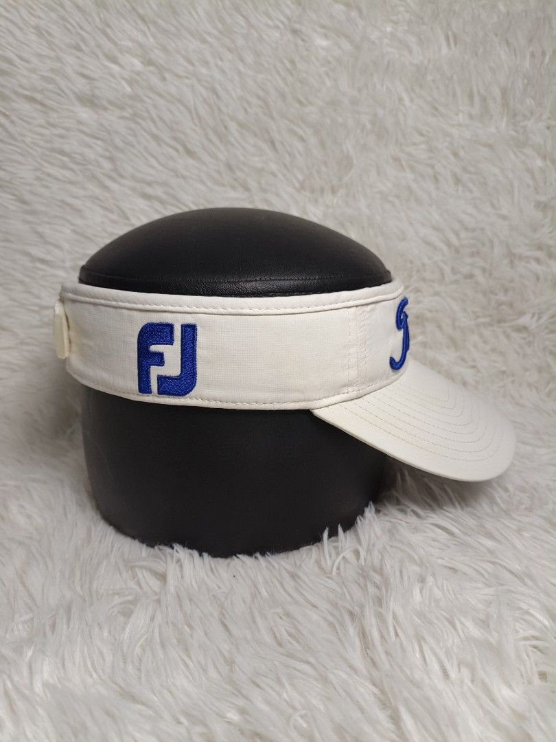 Titleist FootJoy Golf Visor White Blue (Category: Golf) located in Imus. Submitted by grindhouse.thriftshop (Listing ID 1467060733, Image 2). Description: - Brand: Titleist & FootJoy - Color: White with gray under-brim - Design: Titleist embroidery on front, FJ logo on side - Closure: Adjustable strap with branded red & black patch - Condition: Excellent / Ready to use - Perfect for golf, tennis, and outdoor activities.