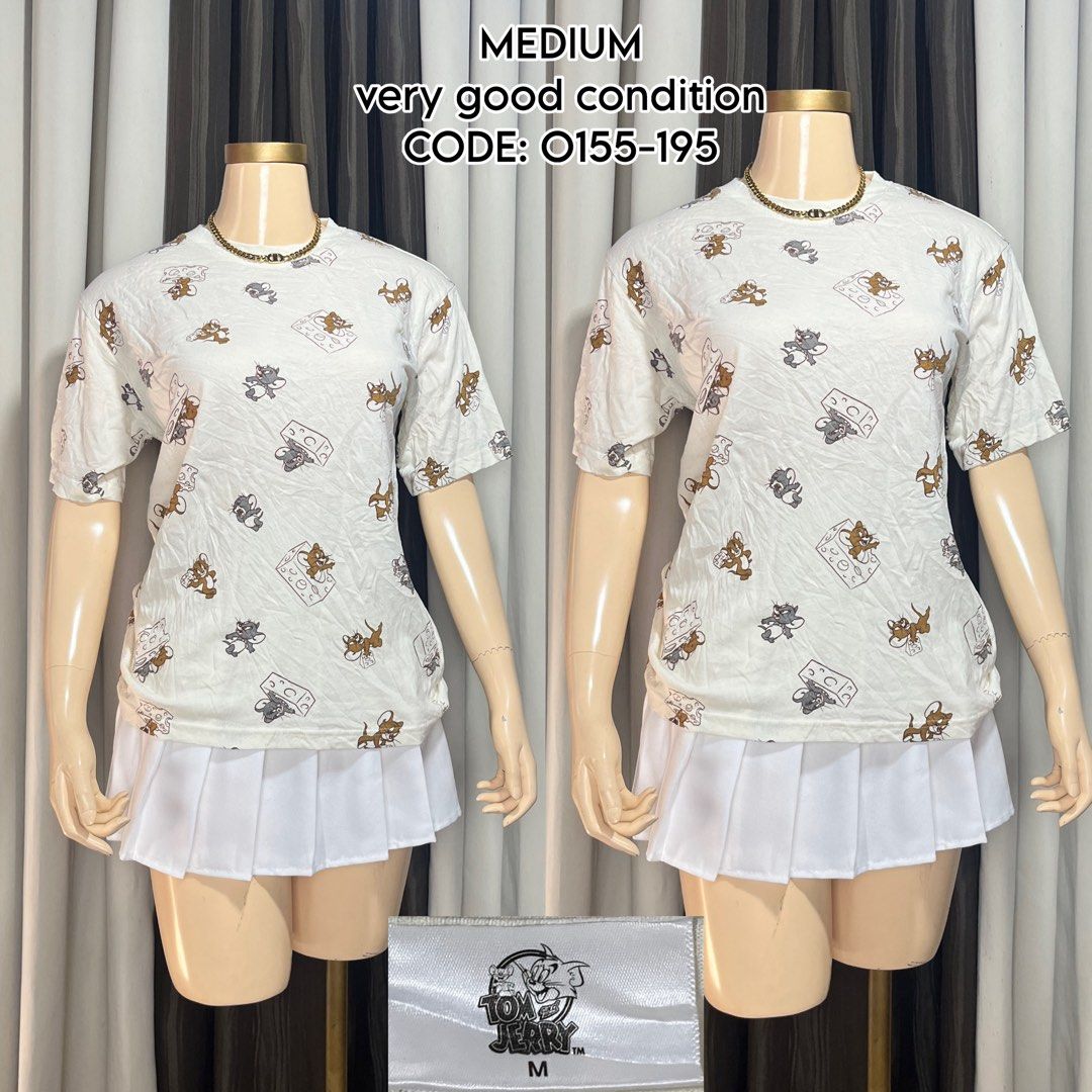 Tom and Jerry White Graphic T-Shirt Medium (Category: Shirts) located in Naga. Submitted by rmapprl (Listing ID 1467093656, Image 1). Description: - Design: White graphic tee with Tom and Jerry & cheese block prints - Fit: Classic casual fit, Size Medium - Details: Short sleeves, crew neck, size tag near hem - Styling: Easy to match with skirts or denim shorts - Condition: Brand new.