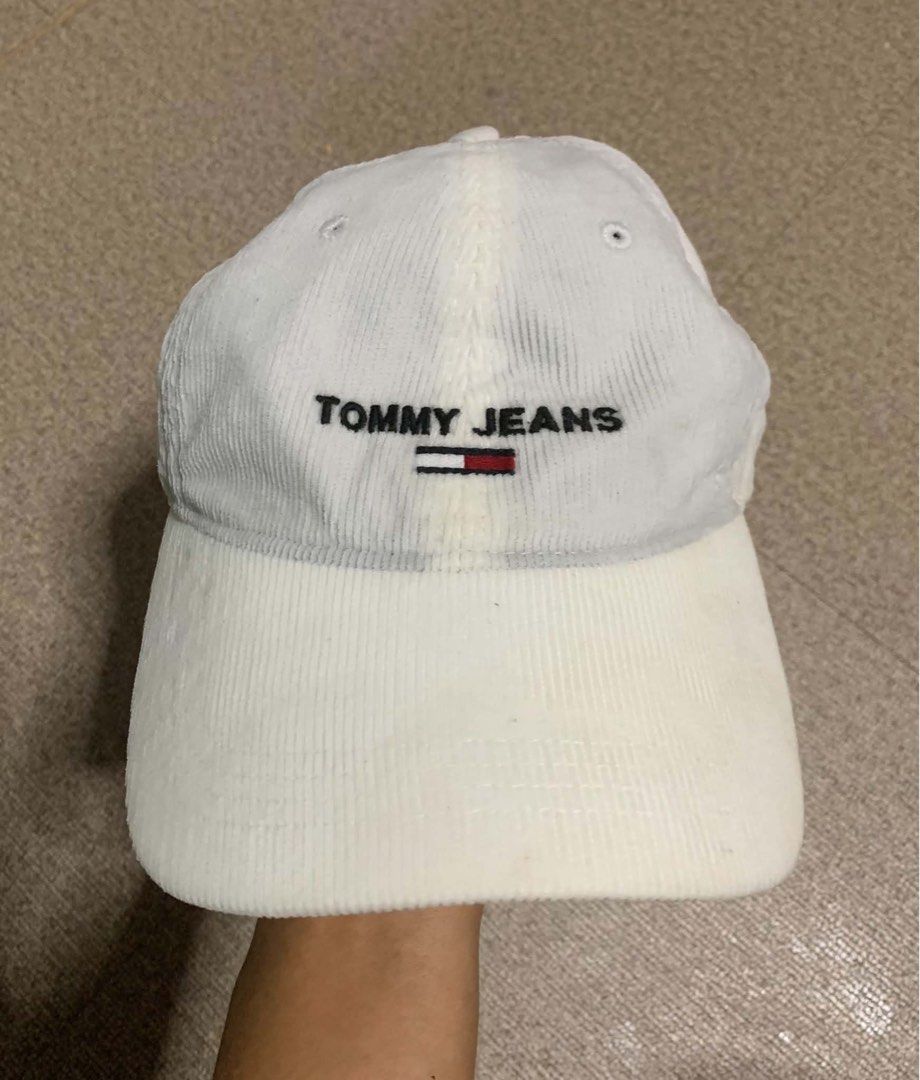 Tommy Jeans Corduroy Baseball Cap (Category: Caps & Hats) located in Tagum. Submitted by knilevinc69480 (Listing ID 1467120880, Image 1). Description: - Brand: Tommy Jeans - Material: White corduroy - Design: Embroidered logo on the front - Fit: Adjustable metal strap in the back (One Size Fits All tag attached) - Details: Branded interior tape - Condition: Clean and ready to wear.
