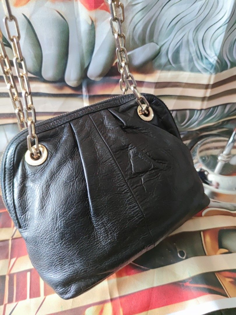 Tory Burch Black Distressed Leather Convertible chain Bag (Category: Luxury Bags & Wallets) located in Dagupan City. Submitted by jhazrightshop (Listing ID 1467057160, Image 3). Description: - Brand: Tory Burch - Material: Premium black crinkled leather with gold-tone hardware - Design: Slouchy pleated front and back panels with prominent front logo medallion - Straps: Double chain straps with leather guards for comfortable shoulder wear - Closur