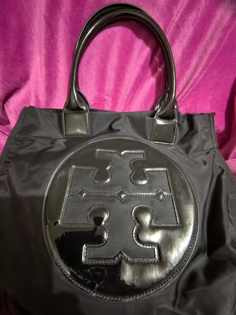 Tory Burch Black Nylon Tote Bag (Category: Tote Bags) located in Manila. Submitted by jsu2026 (Listing ID 1467097097, Image 2). Description: Authentic Tory Burch Ella Patent Nylon Tote Bag - Black (Excellent Condition) Description: Selling my authentic Tory Burch Ella Tote Bag in classic black nylon with glossy patent leather trim. This is the large size, perfect as a daily work bag, school tote, or a lightweight travel carry-on that easily fits 
