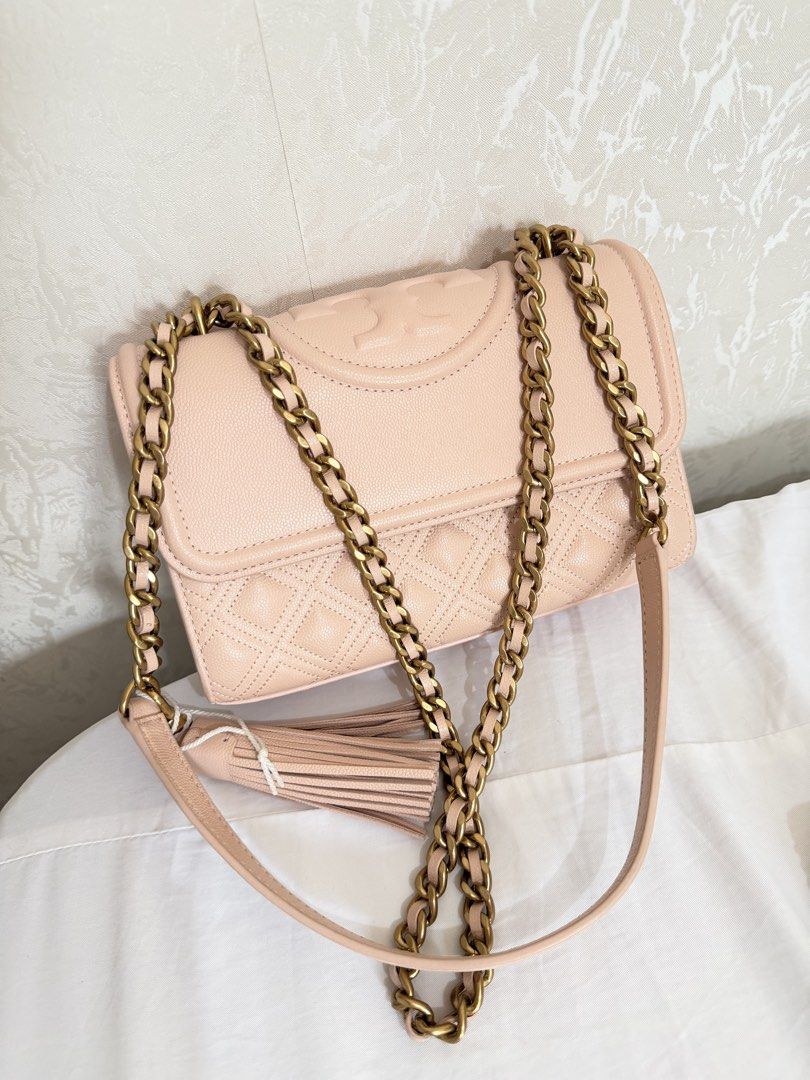 Tory Burch Fleming Quilted Leather Convertible Shoulder Bag Pink (Category: Luxury Bags & Wallets) located in Cebu City. Submitted by cutexoxoshop (Listing ID 1466973213, Image 2). Description: - Brand: Tory Burch - Color: Soft pink - Material: Quilted leather with diamond pattern - Hardware: Heavy antique brass - Features: Embossed double T logo, flap closure, and leather tassel charm - Strap: Chain strap with leather shoulder guard for shoulder