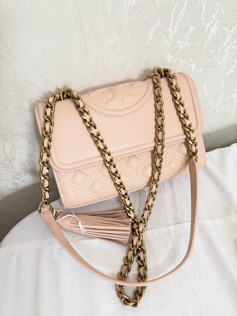 Tory Burch Fleming Quilted Leather Convertible Shoulder Bag Pink (Category: Luxury Bags & Wallets) located in Cebu City. Submitted by cutexoxoshop (Listing ID 1466973213, Image 1). Description: - Brand: Tory Burch - Color: Soft pink - Material: Quilted leather with diamond pattern - Hardware: Heavy antique brass - Features: Embossed double T logo, flap closure, and leather tassel charm - Strap: Chain strap with leather shoulder guard for shoulder