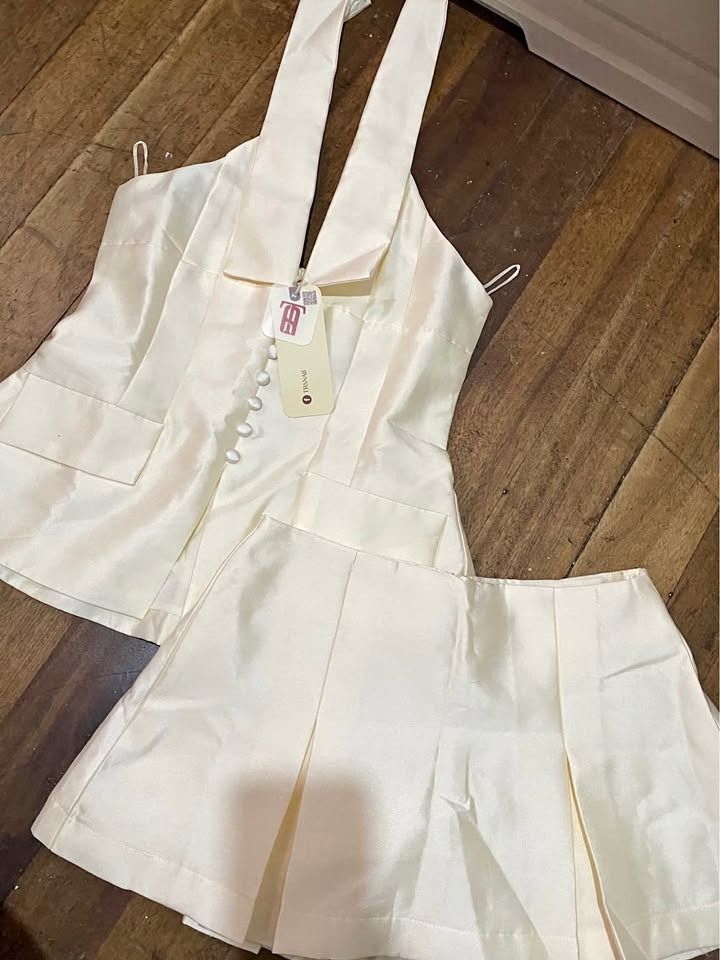 Halter Top & Mini Skirt Coords Vietnam (Category: Sets or Coordinates) located in Caloocan City. Submitted by ish.declutters (Listing ID 1467005654, Image 1). Description: - Color: Cream - Set includes: Halter neck vest top and pleated skirt - Vest details: Button-up front and built-in straps - Skirt details: Wide box pleats all around - Material: Smooth, satin-like fabric 🚚 Mode of delivery: J&T/Lalamove 🏦 Mode of payment: Gcash 📍 Location: B