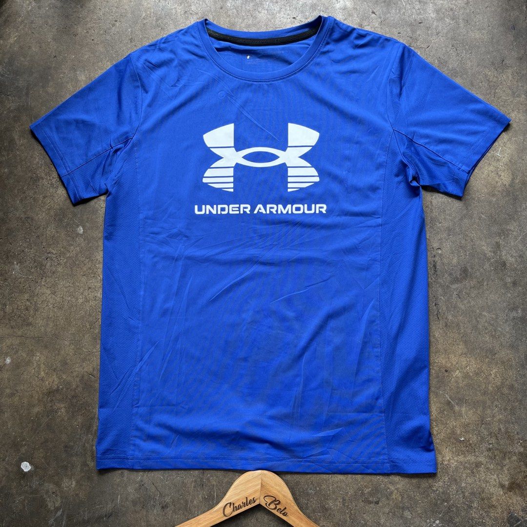 Under Armour Blue Athletic T-shirt (Category: Activewear) located in Davao. Submitted by charlesole52665 (Listing ID 1467139250, Image 1). Description: - Brand: Under Armour - Color: Bright blue with white chest logo - Size: Large (170/84) on tag - Width:20 inch - Length: 26.5 inch - Material: Lightweight body (87.5% polyester, 12.5% spandex) with breathable side panels (90% polyester, 10% spandex) - Condition: Clean inside collar branding, excel