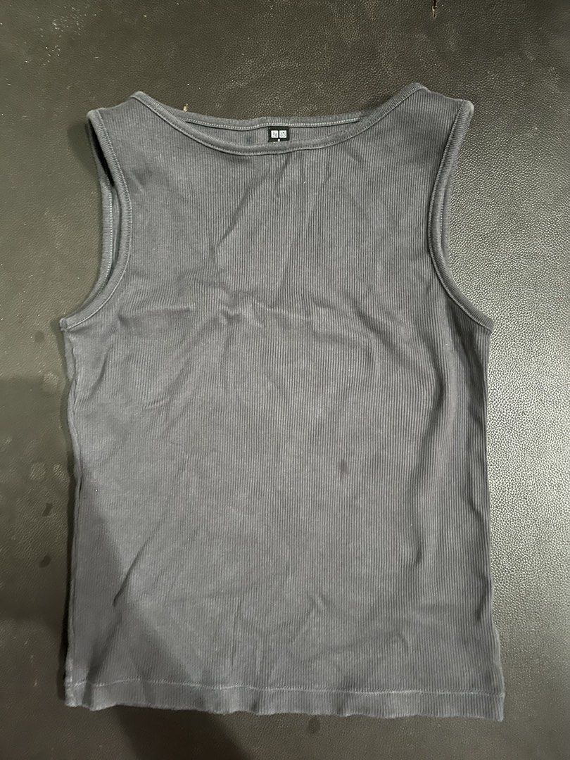 Uniqlo Grey Ribbed Tank Top (Category: Sleeveless) located in Manila. Submitted by rhiangastadora (Listing ID 1467026571, Image 1). Description: - Brand: Uniqlo - Color: Dark Grey - Material: 96% Cotton, 4% Spandex (soft & stretchable) - Design: Classic scoop neckline, sleeveless - Fit: Comfortable basic, easy to pair with jeans or skirts.