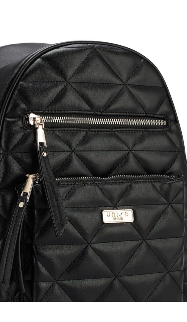 Unisa Black Quilted Backpack (Category: Backpacks) located in Mandaluyong City. Submitted by katsandkisses (Listing ID 1467148262, Image 3). Description: - Brand: Unisa - Color: Classic Black - Material: Clean, durable faux leather - Design: Elegant quilted diamond pattern with gold metal logo plaque - Compartments: Secure top zip closure and convenient front zip pocket - Straps: Comfortable, adjustable shoulder straps - Extra: Protective metal f