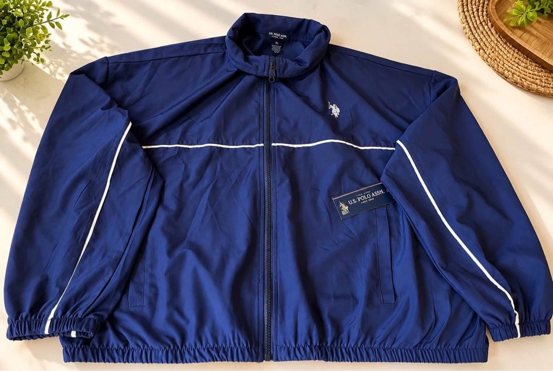 US Polo ASSN. Unisex Windbreaker (Category: Coats, Jackets and Outerwear) located in Santa Rosa. Submitted by ninaparis (Listing ID 1466983352, Image 3). Description: Original USPA Unisex Windbreaker Jacket size Xl can fit to large.
