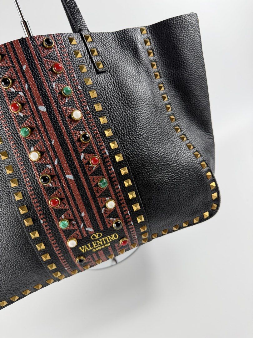Valentino Garavani - Rockstud Tote (Category: Tote Bags) located in Mabalacat. Submitted by seanthep (Listing ID 1467104059, Image 3). Description: Valentino - Rockstud Tote Width: 18” Height: 10” Can fit laptop and many things All beads design are complete intact No rubs and scratch on every corners.