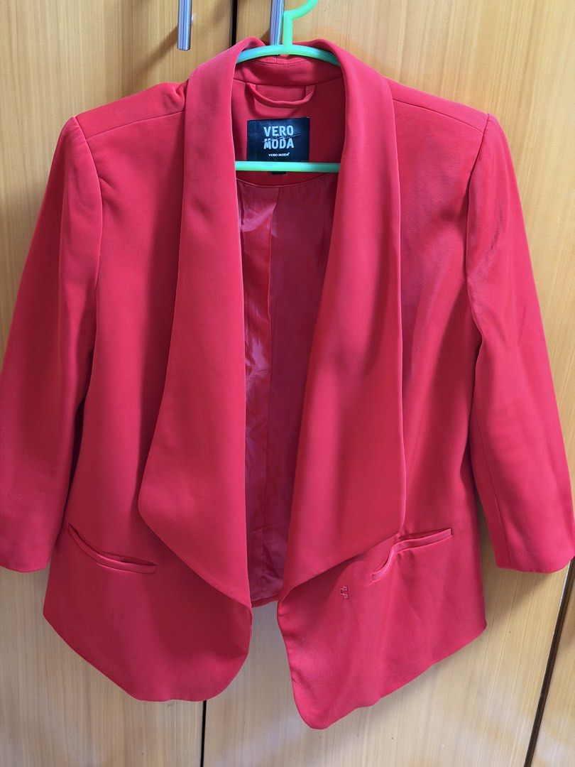 Vero Moda Red Blazer Small (Category: Coats, Jackets and Outerwear) located in Bacoor. Submitted by happyfish_028a6c (Listing ID 1467116428, Image 2). Description: - Brand: Vero Moda - Color: Bright red - Style: Open front with draped lapels - Details: Two front welt pockets, fully lined interior, structured shoulders - Fit: Comfortable and easy to layer over basics - Occasion: Perfect for workwear or smart casual outfits.