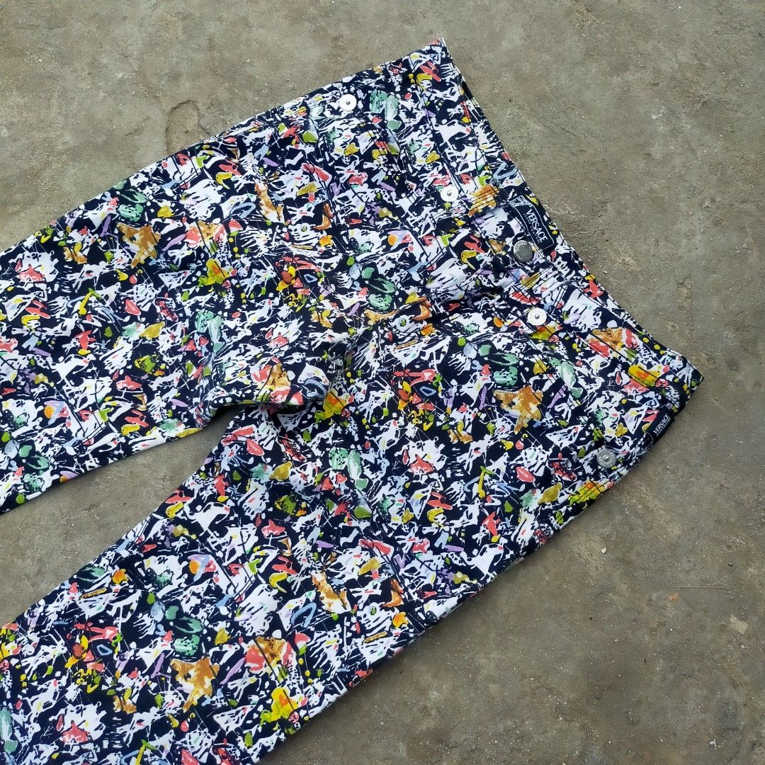 Versace Jeans Couture Multicolored Abstract Print Pants (Category: Jeans) located in Zamboanga. Submitted by _oliverbmth (Listing ID 1467035736, Image 2). Description: - Brand: Versace Jeans Couture - Style: Loud, multicolored abstract all-over print statement pants - Colors: Vibrant palette of black, white, red, yellow, and green - Details: Classic five-pocket design with metallic branded rivets - Branding: Signature silver metallic back patch f