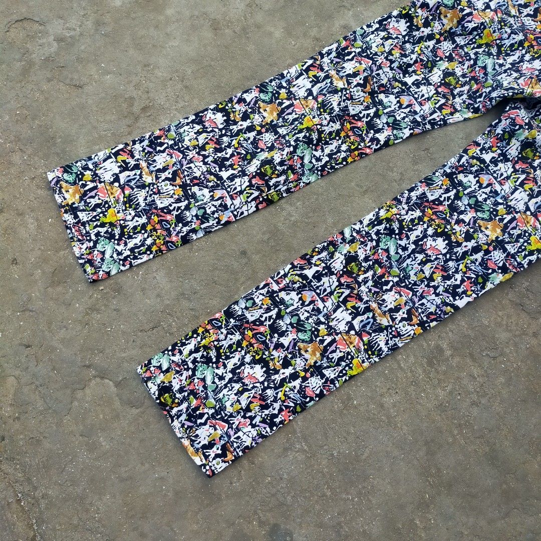 Versace Jeans Couture Multicolored Abstract Print Pants (Category: Jeans) located in Zamboanga. Submitted by _oliverbmth (Listing ID 1467035736, Image 3). Description: - Brand: Versace Jeans Couture - Style: Loud, multicolored abstract all-over print statement pants - Colors: Vibrant palette of black, white, red, yellow, and green - Details: Classic five-pocket design with metallic branded rivets - Branding: Signature silver metallic back patch f