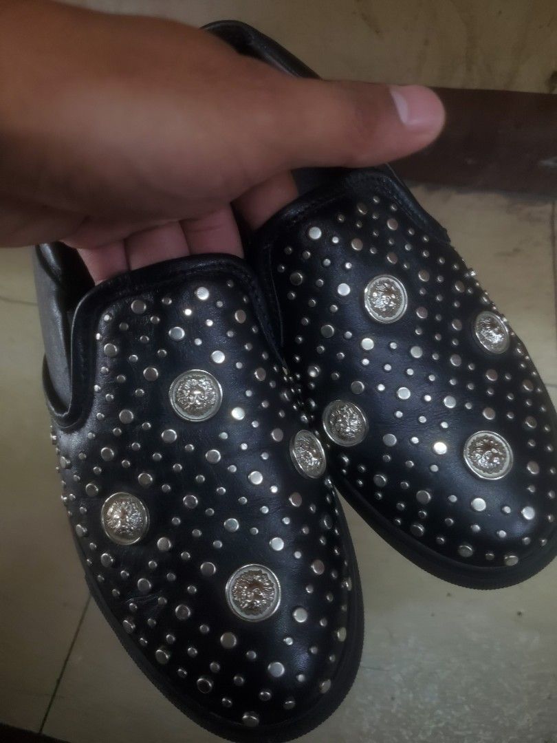 Versus Versace Black Studded Slip-On Shoes (Category: Sneakers) located in Manila. Submitted by royalrabbit.7b2a11 (Listing ID 1467104201, Image 2). Description: - Brand: Versus Versace - Material: Premium black leather - Design: Silver studs with signature lion head hardware - Sole: Thick black rubber with embossed heel and outsole branding - Interior: Stamped Versus Versace logo insoles - Condition: Excellent, highly comfortable for daily wear 