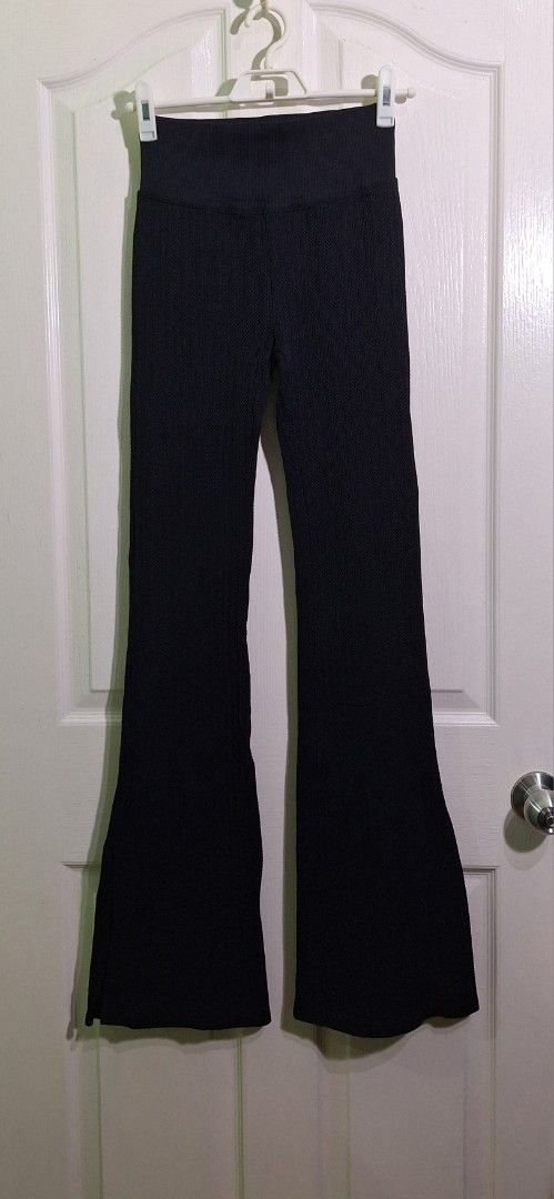 Victoria's secret pink soft cable flare split hem small (Category: Other Bottoms) located in San Pablo. Submitted by allyourbrandedneeds (Listing ID 1467040433, Image 3). Description: - Color: Black - Style: High-waisted ribbed flared pants with side slits - Fabric: Thick, stretch knit with vertical texture - Features: Wide high waistband, pull-on style, small side slit near the hem - Versatile: Great for workouts, casual wear, or lounging in sty