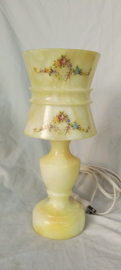 Vintage Alabaster Stone Floral Accent Table Lamp (Category: Lighting) located in Quezon City. Submitted by jpnvintageonline (Listing ID 1466996421, Image 2). Description: - Material: Heavy yellow alabaster stone with a classic turned pedestal base - Design: Beautiful hand-painted floral garlands around the shade - Details: Includes standard white cord with plug and a working bulb - Condition: Excellent, ready for display - Perfect for: Adding a w