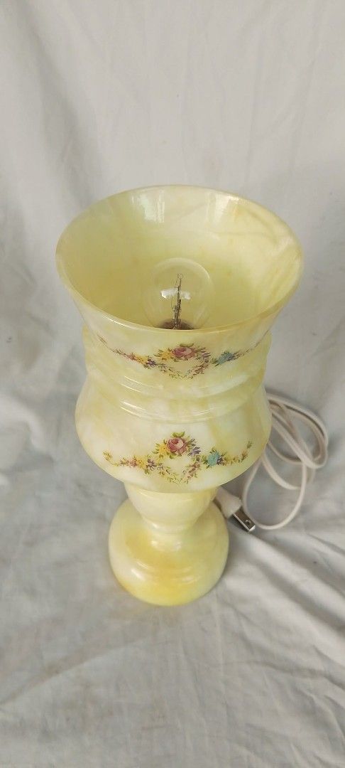 Vintage Alabaster Stone Floral Accent Table Lamp (Category: Lighting) located in Quezon City. Submitted by jpnvintageonline (Listing ID 1466996421, Image 3). Description: - Material: Heavy yellow alabaster stone with a classic turned pedestal base - Design: Beautiful hand-painted floral garlands around the shade - Details: Includes standard white cord with plug and a working bulb - Condition: Excellent, ready for display - Perfect for: Adding a w
