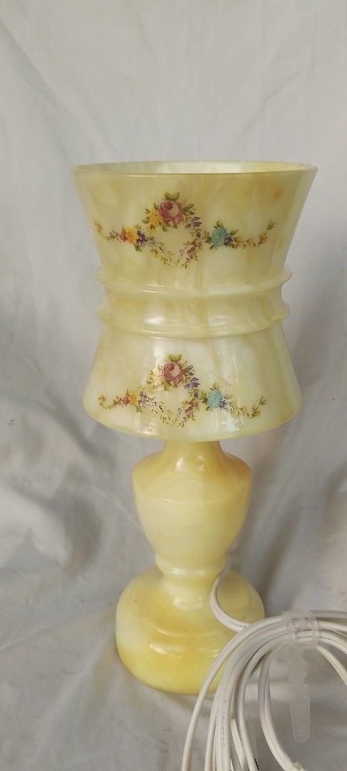 Vintage Alabaster Stone Floral Accent Table Lamp (Category: Lighting) located in Quezon City. Submitted by jpnvintageonline (Listing ID 1466996421, Image 1). Description: - Material: Heavy yellow alabaster stone with a classic turned pedestal base - Design: Beautiful hand-painted floral garlands around the shade - Details: Includes standard white cord with plug and a working bulb - Condition: Excellent, ready for display - Perfect for: Adding a w