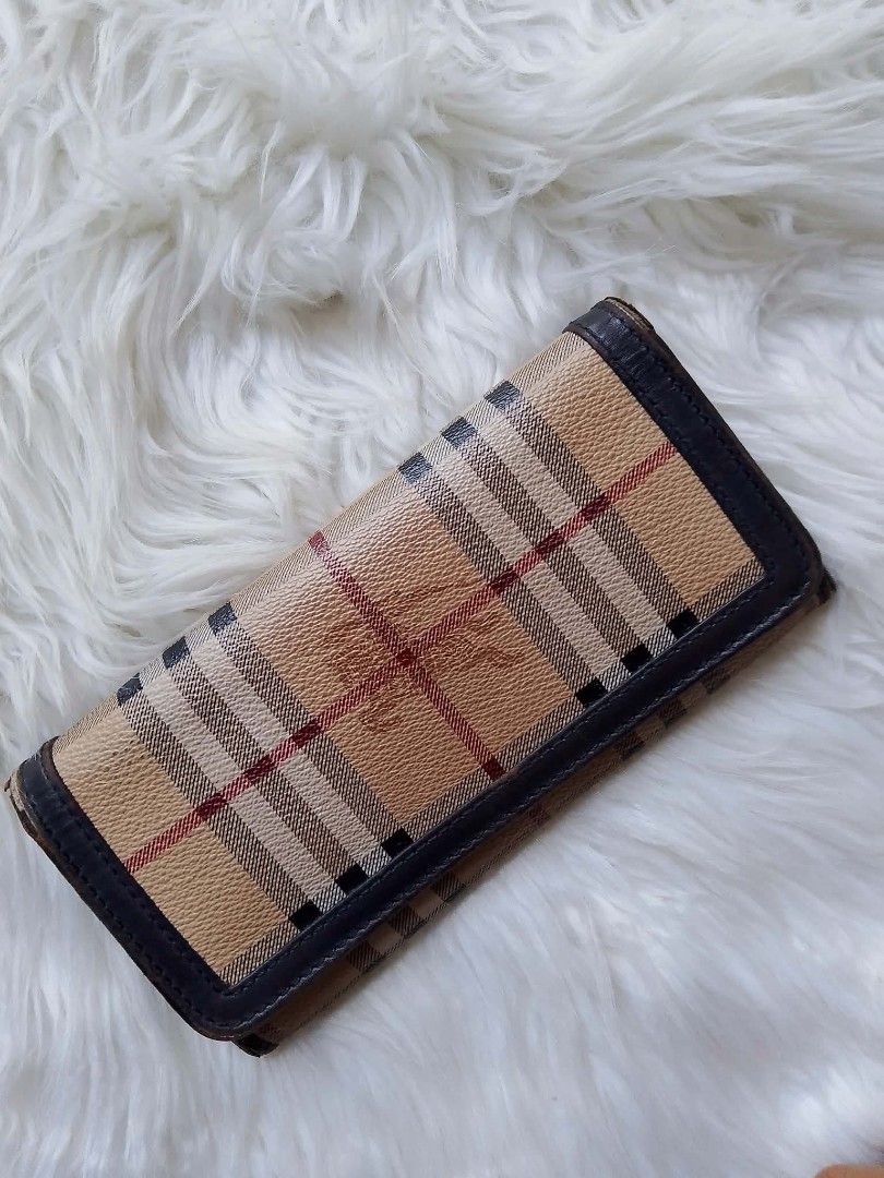 Vintage Burberry Check Long Wallet (Category: Wallets & Card holders) located in Midsayap. Submitted by purse_gedo (Listing ID 1466998533, Image 1). Description: Burberry long wallet with iconic check print and equestrian knight logo debossed on the front. Dark brown leather trim and interior lining. Snap button closure. Multiple card slots, cash compartments, and a zippered coin pocket inside. Stamped Made in Italy on the interior leather..