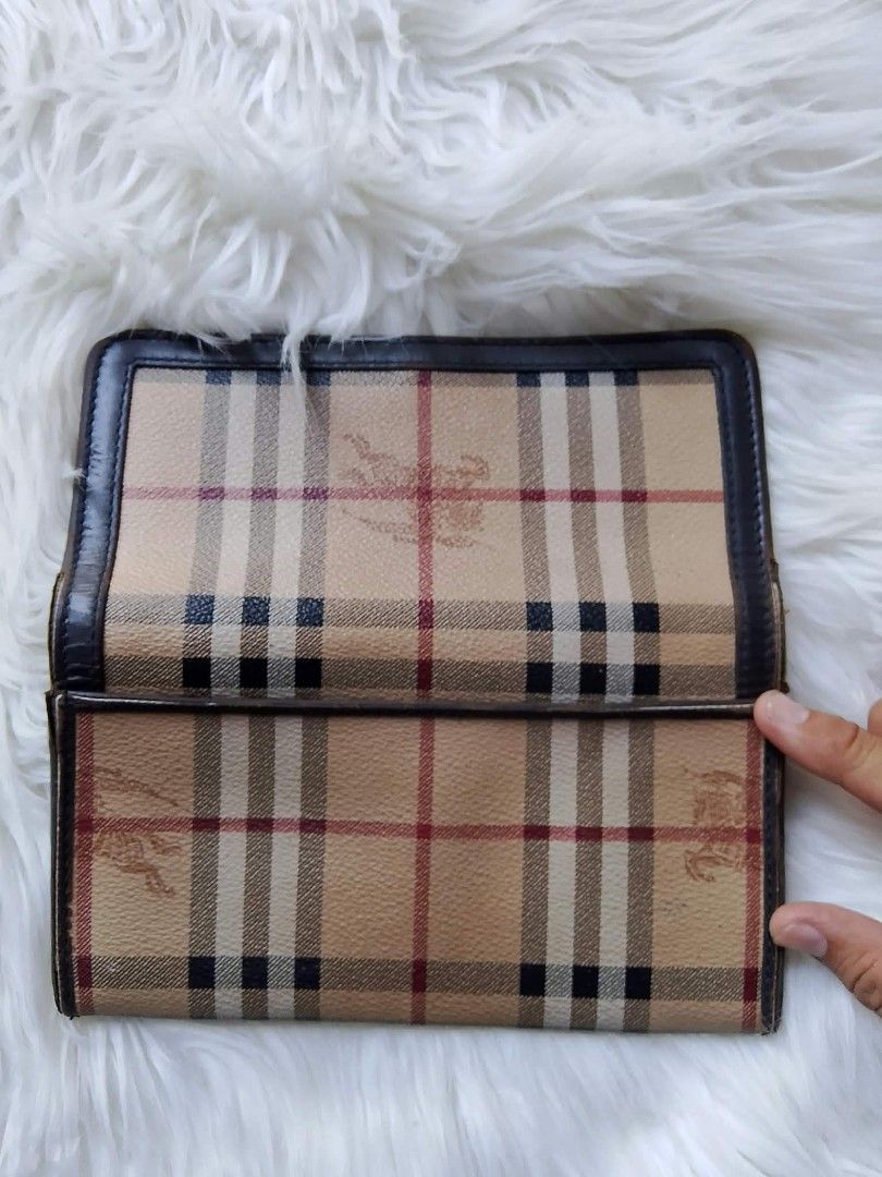 Vintage Burberry Check Long Wallet (Category: Wallets & Card holders) located in Midsayap. Submitted by purse_gedo (Listing ID 1466998533, Image 3). Description: Burberry long wallet with iconic check print and equestrian knight logo debossed on the front. Dark brown leather trim and interior lining. Snap button closure. Multiple card slots, cash compartments, and a zippered coin pocket inside. Stamped Made in Italy on the interior leather..