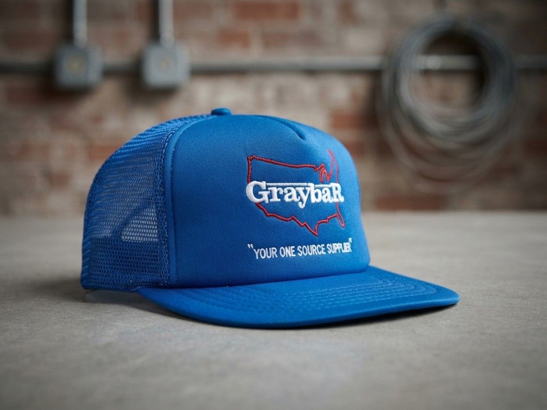 Vintage Graybar Blue Mesh Trucker Hat (Category: Caps & Hats) located in Binangonan. Submitted by yuristalin888 (Listing ID 1466977547, Image 1). Description: Product Description: Classic royal blue vintage trucker hat featuring embroidered Graybar branding, a red USA map outline, and the slogan “Your One Source Supplier.” Made with a 100% polyester front and 100% nylon mesh back for breathable comfort. Includes a curved brim and adjustable snapb