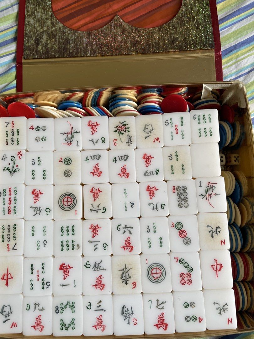 Vintage Mahjong Set with dice and Chips (Category: Board Games & Puzzles) located in Cebu City. Submitted by modelrunway (Listing ID 1466989156, Image 1). Description: - Complete mahjong set featuring traditional white tiles with classic Chinese character, circle, and bamboo carvings - Housed in a stunning decorated gold box branded with RAPTURE on the side - Includes a shiny gold interior, red ribbon handle, and multicolored gaming chips - Perfe